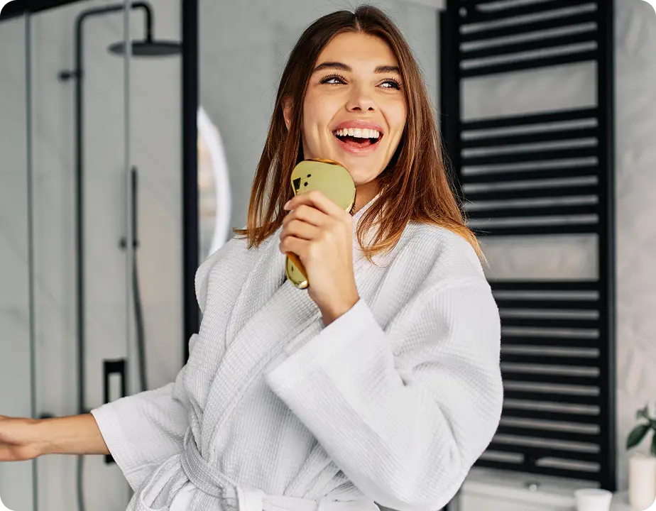 Happy homeowner in a beautifully remodeled bathroom